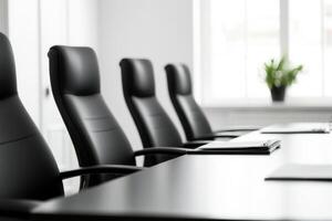 Conference room, Rows of empty black chairs face a table with files. Ready for a meeting photo