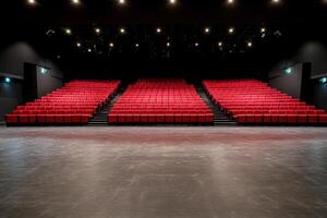 Empty stage with rows of unoccupied red seats in a theatre or auditorium ready for a show photo