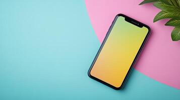 Colorful Mobile Phone on Pastel Background with Green Leaf Accent photo