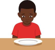 A young boy with a solemn expression sitting at a wooden table staring at an empty plate in a flat illustration vector