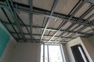 structure of ceiling suspension, installation of gypsum plasterboard and light. photo