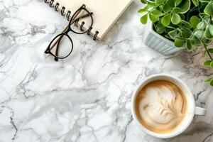 Overhead Shot of Coffee Cup, Notebook, and Glasses on Marble Isolated on White Background photo