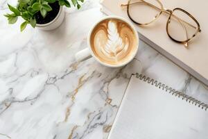 Top View Arrangement of Coffee Cup, Notebook, and Glasses on Marble Isolated on White Background photo