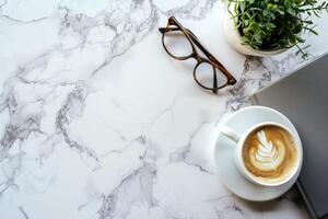 Top View Coffee Cup, Notebook, and Eyeglasses on Marble Isolated on White Background photo