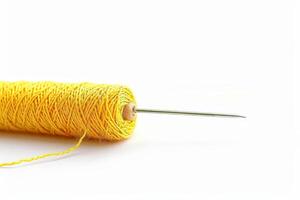 Lemon Yellow Thread with Needle for Stitching Isolated on White Background photo
