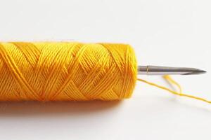 Yellow Embroidery Thread and Needle Isolated on White Background photo