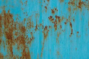turquoise painted steel surface with stains of rust - full-frame background and texture photo