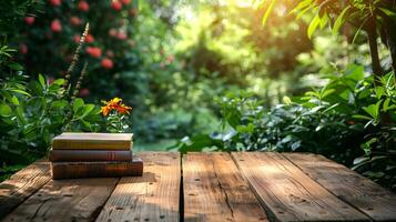 wooden table top with pile of books on fresh morning garden background photo