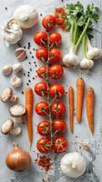 Fresh vegetables like tomatoes, carrots and garlic are neatly organized photo