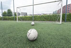 Green grass and white border lines on football ground. Soccer field on artificial turf. Artificial green grass texture. Artificial football field in an open stadium photo