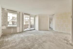 An empty room with a large window and a door photo