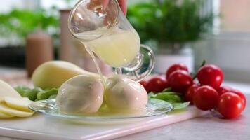 Mozzarella Caciocavalo Filling molds for the production of soft cheese. The cheese blanks are soaked in brine. Cheese factory preparing cheese video