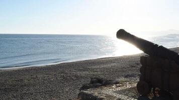 Old cannon of an old fortress in the beach at sunset video