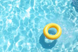 A bright yellow pool float in clear blue water, inviting relaxation. photo