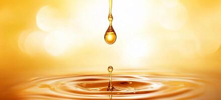 A golden liquid drop creating ripples in a serene setting. photo