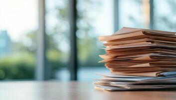 A stack of documents on a desk, indicating work or organization. photo
