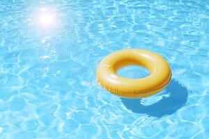 An inflatable yellow ring floating in a pool photo