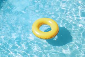 An inflatable yellow ring floating in a pool photo