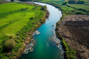 Aerial view of river and garbage in the countryside photo