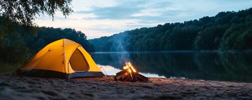 A tent is set up on the shore of a lake photo