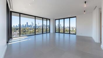 A large empty room with floor to ceiling windows photo