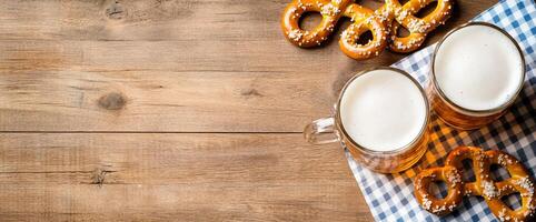 Two glasses of beer with pretzels on a checkered napkin. photo