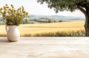 A vase of flowers on a wooden table in front of a field photo