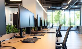 Modern office workspace with computers and ergonomic chairs. photo