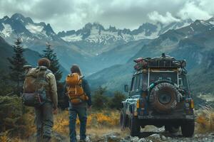 Two people with backpacks standing next to a jeep in the mountains photo