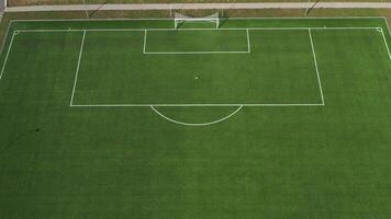 Top view of a football field with green grass outdoors in summer.. video