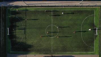 Top view of a Sports soccer field with people playing soccer.a small Football field on the street in the Serebryanka district. Belarus video