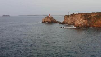 Lighthouse on the coast. A bird's eye view from a drone video