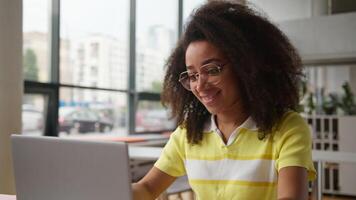 Happy African American woman female student girl in school university college academy close laptop finish using pc complete computer studying learning online class lesson end relaxing pause task done video