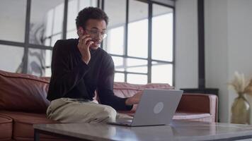 Young Man Talking on Phone While Working video
