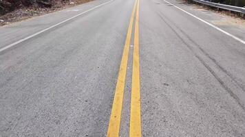 Yellow traffic line color Double solid lines to warn prohibiting overtaking, Yellow continuous tracks of prohibited overtaking painted on the asphalt, Safety driving and traffic video