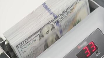 Stack of US Dollar Bills in Money Counting Machine with Digital Display video
