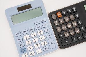 Light blue and black digital calculators on isolated background. Device for calculating the numbers. photo