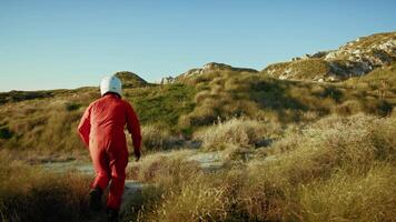 Astronaut Runs Toward An Uninhabited Land On A Hill To Ask For Help video