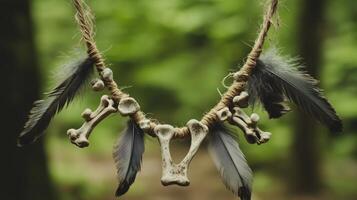 The necklace with weathered bones and dull gray feathers against a forest background. 6 photo