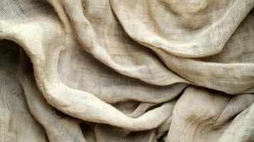 Textured Beige Fabric Draping Creates Abstract Waves and Soft Shadows photo