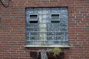Brick wall with glass block window and planter photo