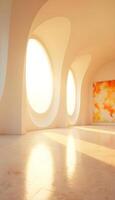 A modern art gallery interior with large oval windows allowing bright sunlight to flood the space. The walls are smooth and white, creating a clean aesthetic. A large abstract painting photo