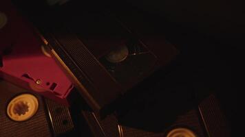 Stack of retro VHS cassettes in moody light video