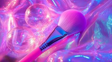 A makeup brush with large bubbles around it, against neon pink fabric. 2 photo