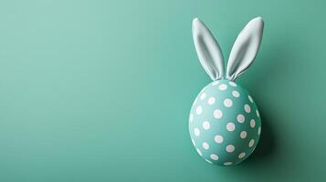 Green polka-dot egg with bunny ears on a green background. 12 photo