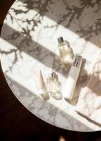 a marble table with bottles of skincare and a towel. Luxurious Skincare Set photo