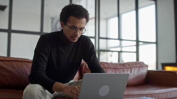 Man Thinking While Working on Laptop at Home video