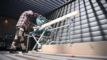 Skilled carpenter working on a precision cut in a well-lit workshop during a productive day video
