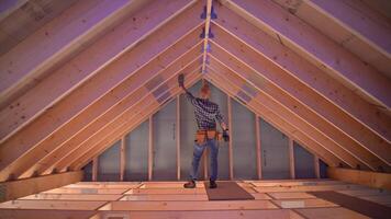Home renovation in progress as worker measures and prepares attic space for improvement video