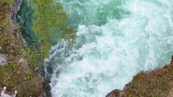 Captivating river flowing through lush landscape near mountains with vibrant blue waters and greenery video